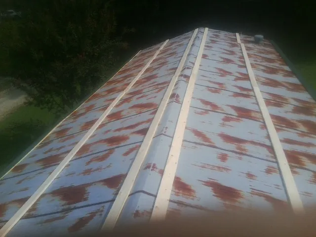 Rusted metal roof panels with new wood purlins before replacement — Storm Damage Roof Repair in Highland Lake by Roofing Brothers