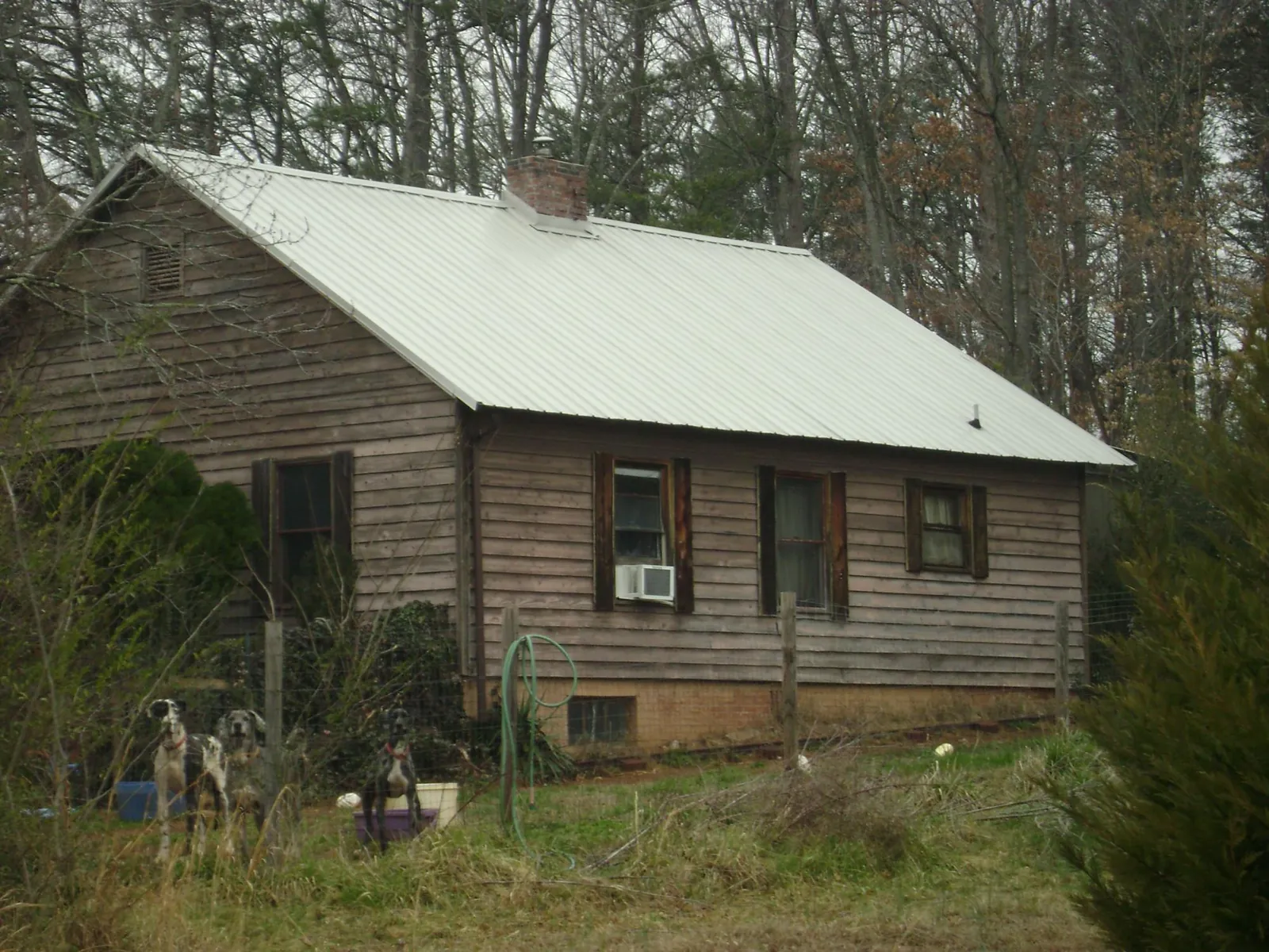 White metal roof on an old wood sided farmhouse, from a Metal Roof Installation job in Highland Lake