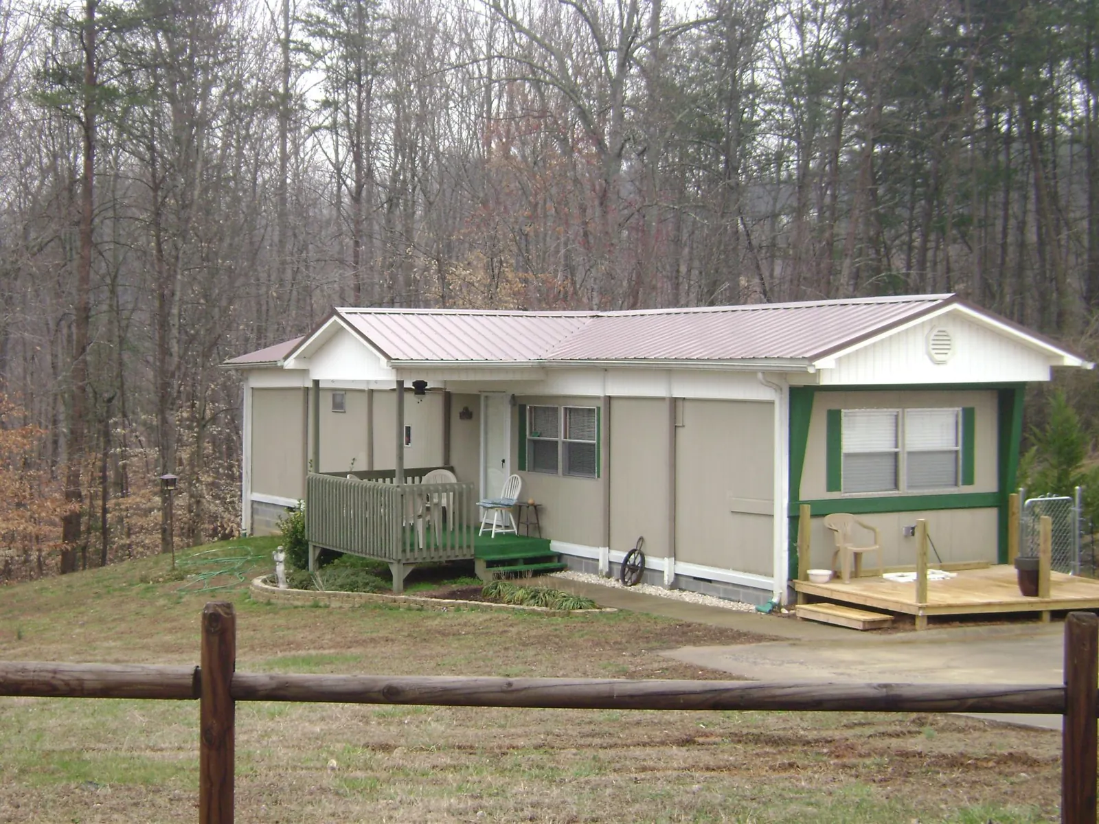 Mauve metal roof on a manufactured home with a new front deck in Highland Lake
